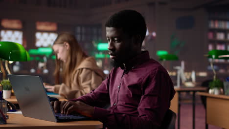 vertical video black male student collecting academic information from the campus library