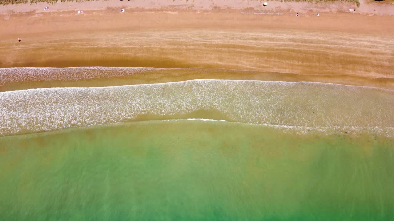 AERIAL Shot of the Waves hitting Long Beach in Russell, New Zealand