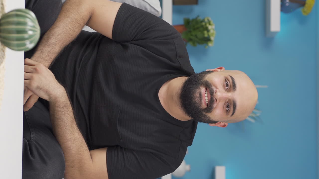 Vertical video of Man making heart symbol for camera.