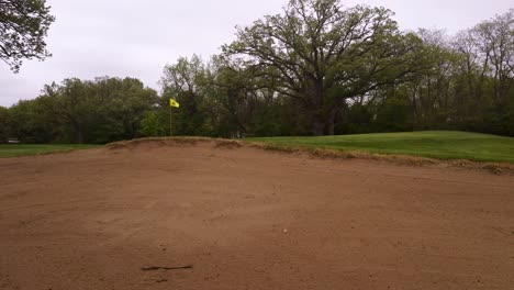 Drone-Footage-Of-Golf-Bunker-In-Golf-Course-With-Beautiful-Green-Lawn