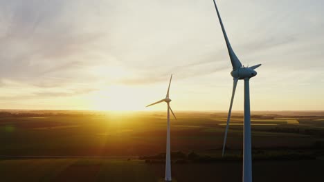 wind turbines at sunset over farmland