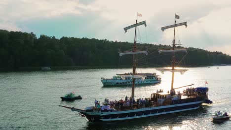 Sailing-boat-escorted-by-other-boats