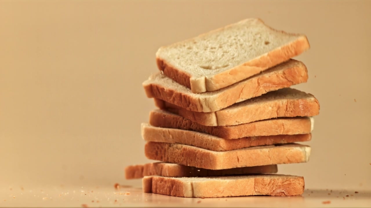 Slow Motion Slices of White Bread Falling and Stacking