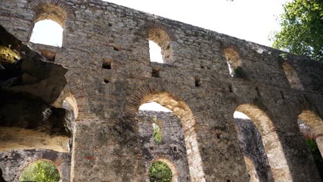 Butrint,-Albania,-a-view-of-a-fragment-of-the-ruined-wall-of-an-ancient-temple-on-a-sunny-day