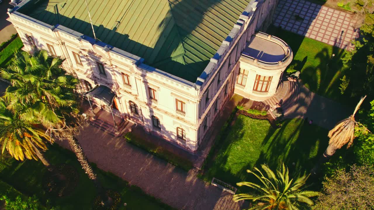 Aerial orbit of the front of the Cousi&ntilde;o palace with square structure and pink color, deciocho neighborhood, Santiago Chile
