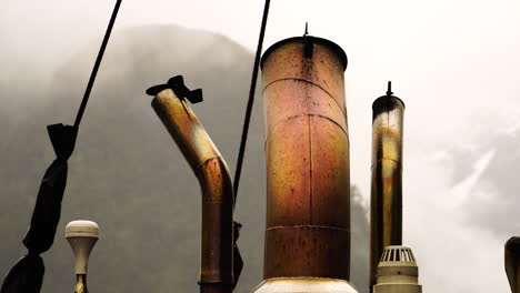 Close-up-of-old-cruise-ship-exhausts-releasing-hot-fumes-while-sailing-outdoors