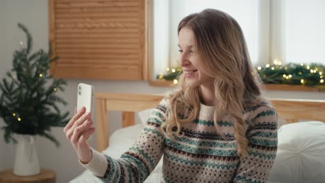 Caucasian-woman-having-video-call-and-showing-Christmas--presents.