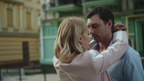 happy couple standing together at street. couple hugging each other outdoors