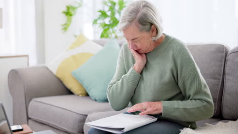 Senior-woman,-stress-and-headache-with-notebook