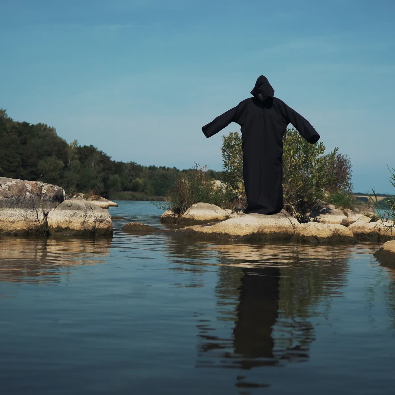 Terrible witch on the river bank. Mysticism of Halloween