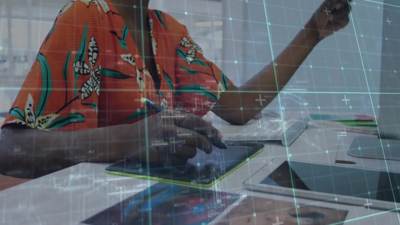 Designer pausing then sketching on tablet while checking phone swatches with animated grid overlay