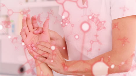 healthcare professional examining wrist with red neuron network animation overlay