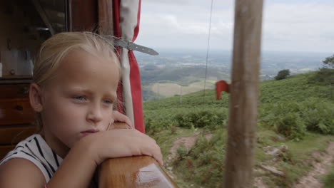 a girl contemplating a scenic train journey through the mountains