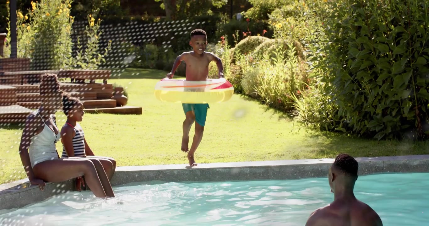 Family at pool, boy grabbing ring, running and jumping for fun, dotted graphic ad showing splash