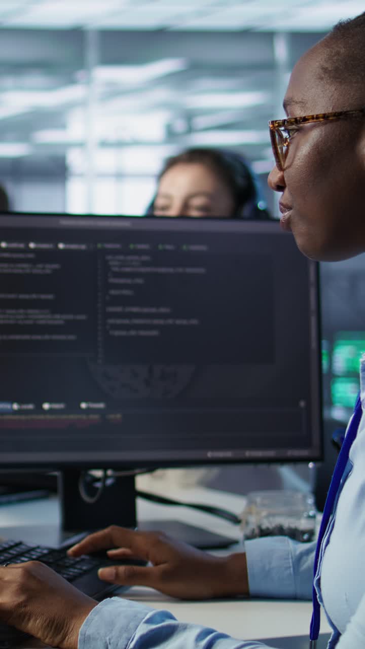 African American Woman Programmer Typing Code on Computer in Office