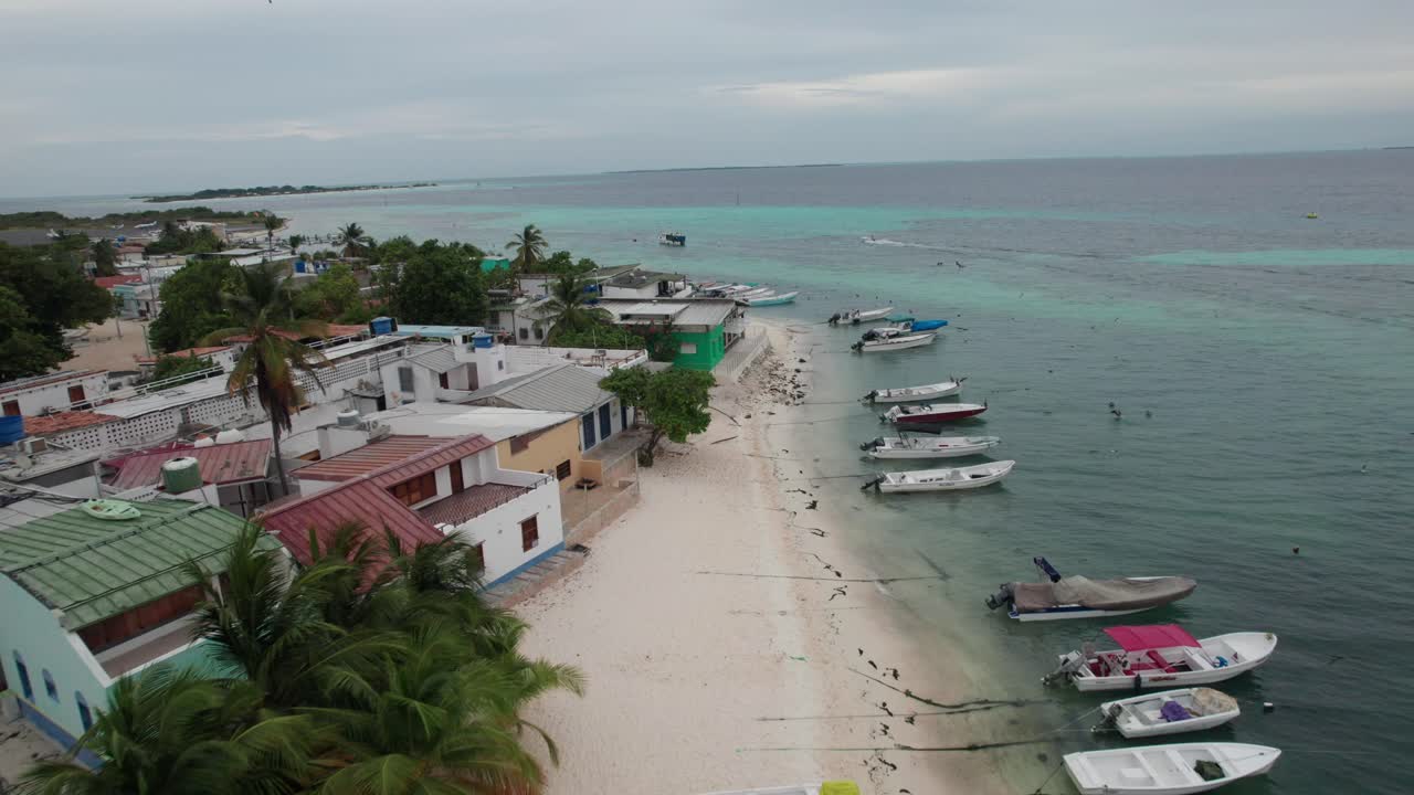 Boats on Los Roques beach create peaceful movement on clear waters