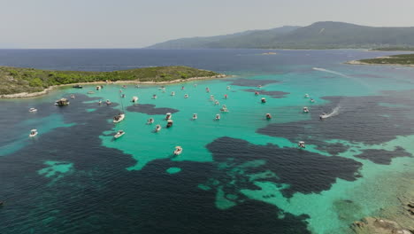 aerial view of boats in a turquoise lagoon