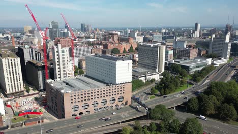 aerial drone flight alongside the mancunian way in manchester giving a panoramic view of manchester city centre