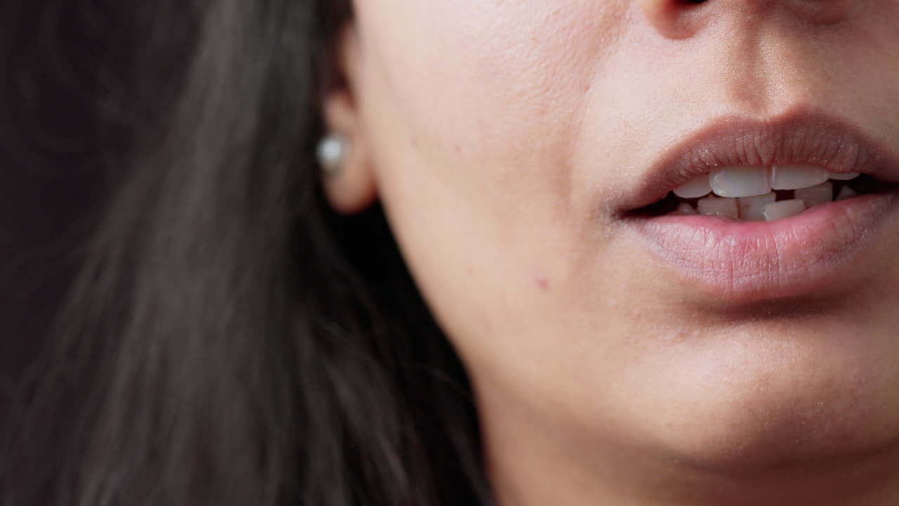 Macro shot of authentic smile with white teeth and fresh makeup