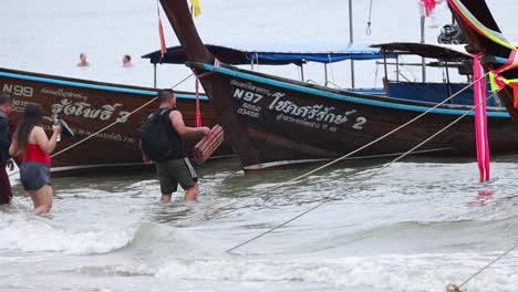 people disembark from a longtail boat