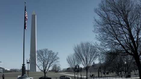 wide shot of the washington monument with american flag