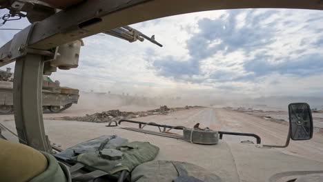 a humvee speeding through war-torn gaza as namer apc heads in opposite direction