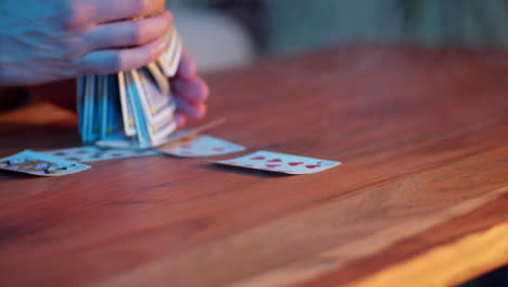 person playing cards on a table