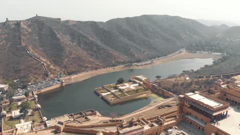 maota lake overlooked by amber fort embellished with kesar kyari garden in jaipur, rajasthan, india - aerial fly-over shot