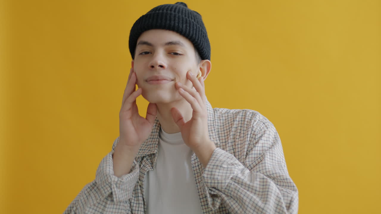 Young Person Posing in Front of Yellow Background