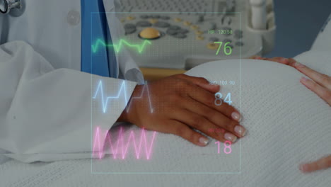 animation of cardiographs over biracial female doctor examining her pregnant patient