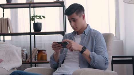 man playing mobile game