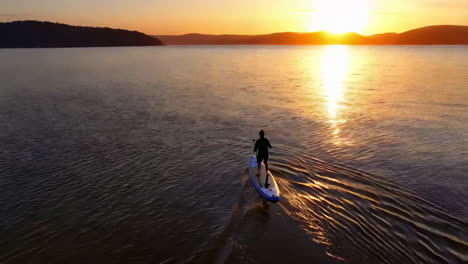 sunset paddleboarding on a calm lake