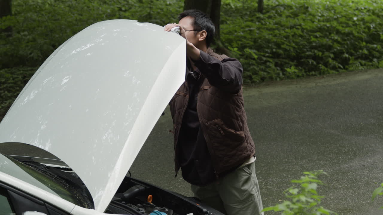 Man inspecting car engine