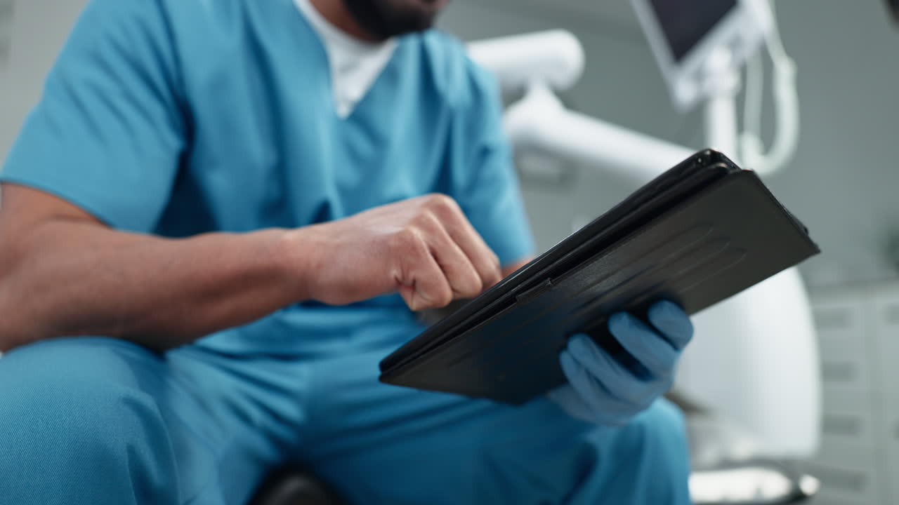 A doctor using a tablet in a dental office