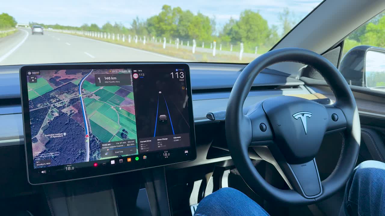 Self-driving vehicle uses autopilot and navigation system on a clear, rural highway