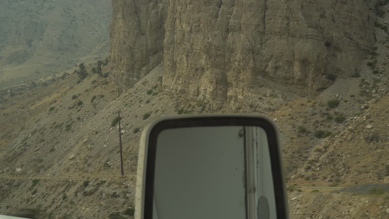 Rural mountains shown through the window of an RV