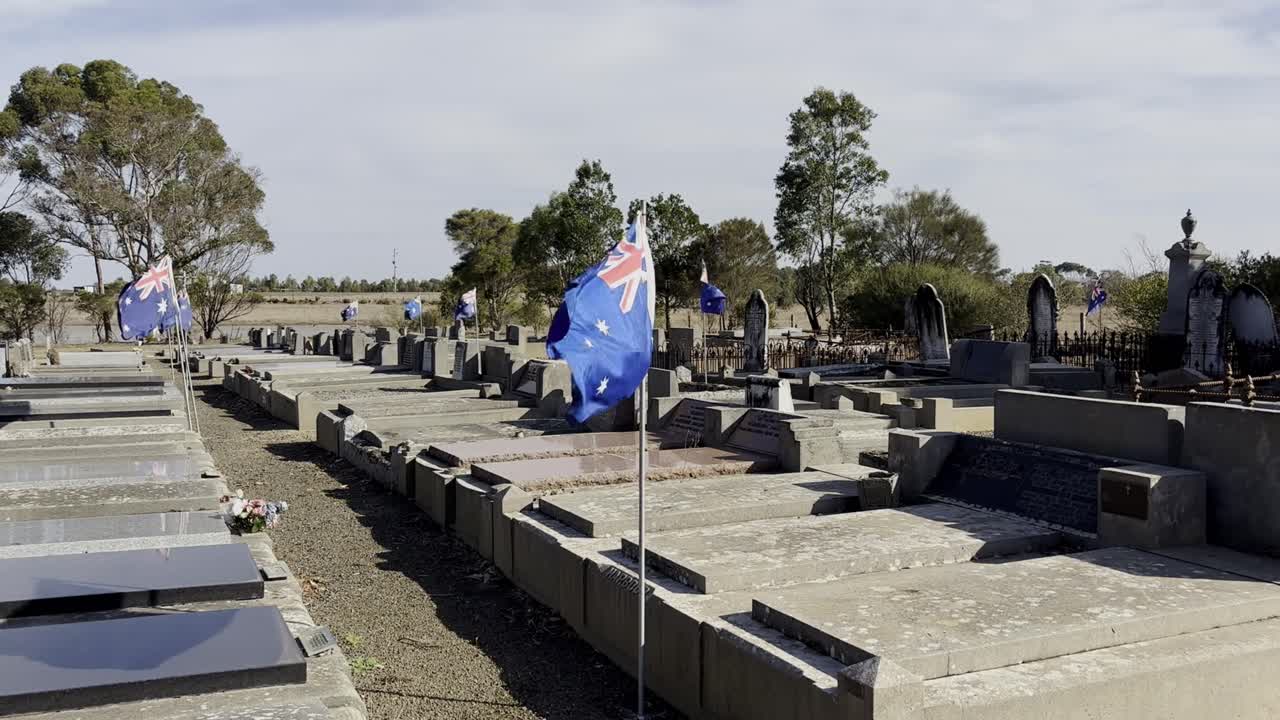 Australian Flag Flying In The Wind At A Grave Of A Fallen War Hero, Anzac Day Celebration.