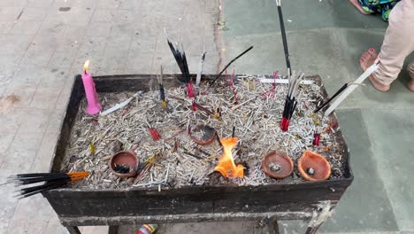 shot of the fire lightened in the temple with dhoop sticks and lamps and candles on the place for lightening the lamps for god in temple side