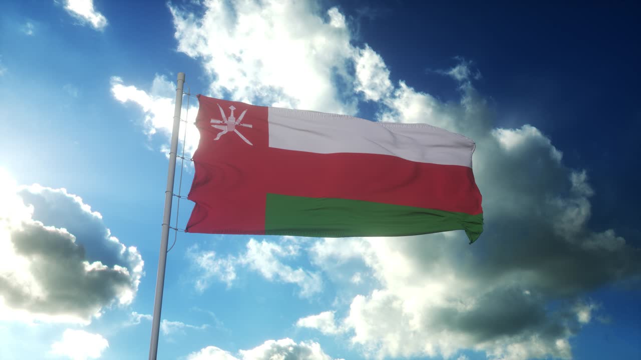 la bandera de omán ondeando en el viento contra un hermoso cielo azul