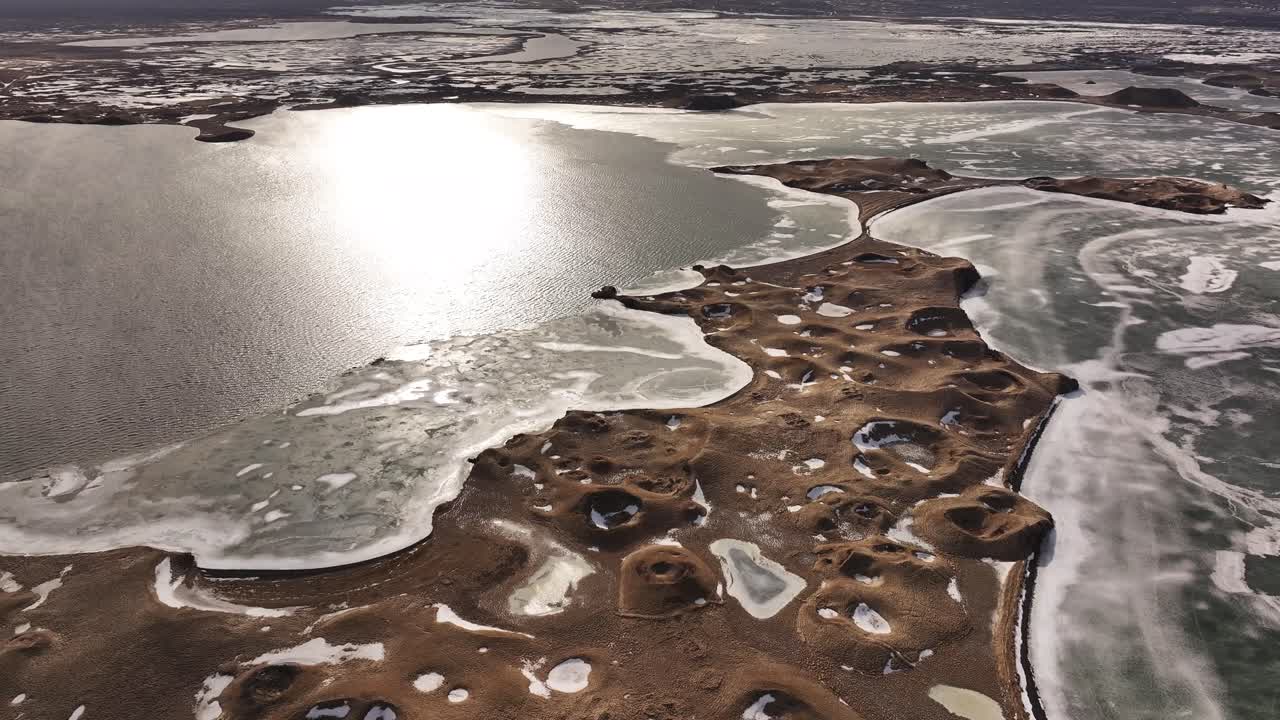aerial frozen lake borders brown snowy Mývatn pseudocraters in Skútustaðir Iceland winter