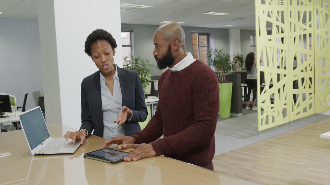 Montage of african american business people and architects working together in office, slow motion