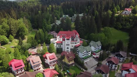 dracula's domain from above: aerial 4k drone shot showcasing 'house of dracula' at poiana brasov ski resort in carpathian mountains