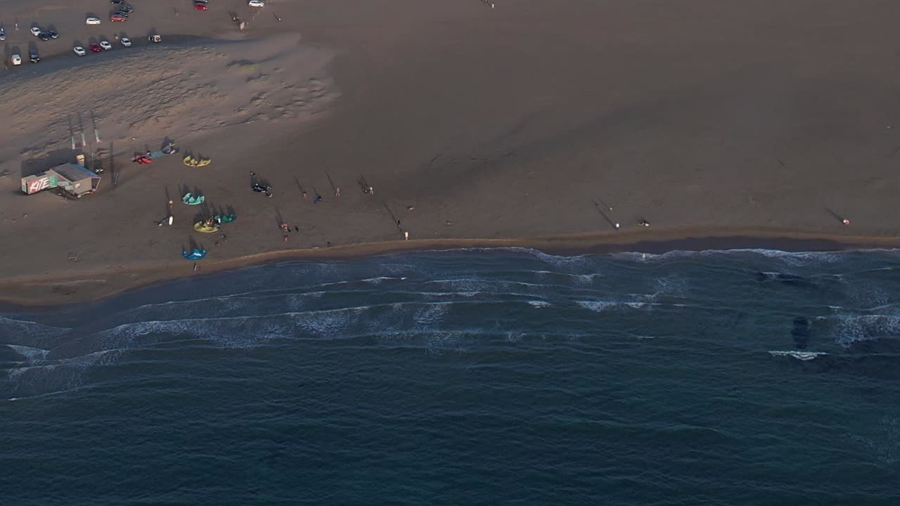 Beautiful aerial view of a beach in Greece with people enjoying the shore