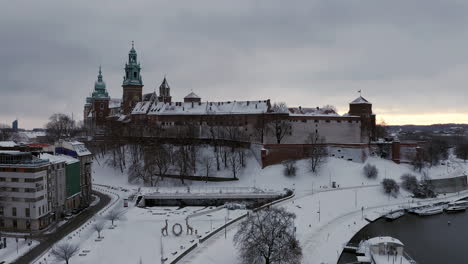 snow-covered wawel castle at cloudy morning, krakow, poland