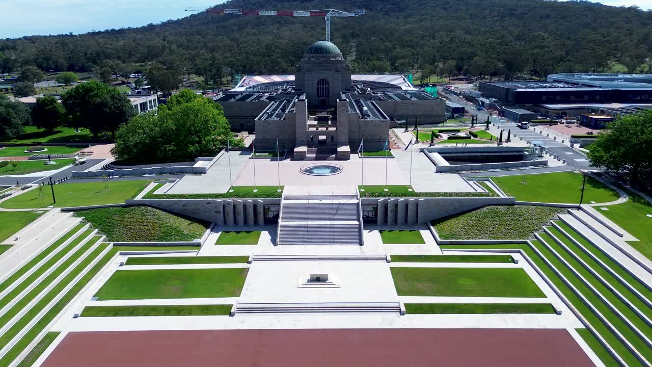 Drone aerial landscape of the Australian War Memorial museum building with entrance staircase promenade and country flags Canberra ACT Anzac Parade Campbell travel tourism capital city
