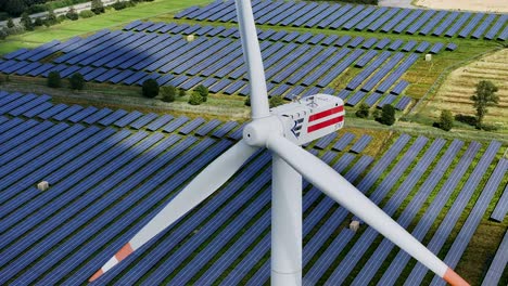 Wind-turbine-producing-clean-energy-in-the-midst-of-a-solar-farm---sustainable-power-production