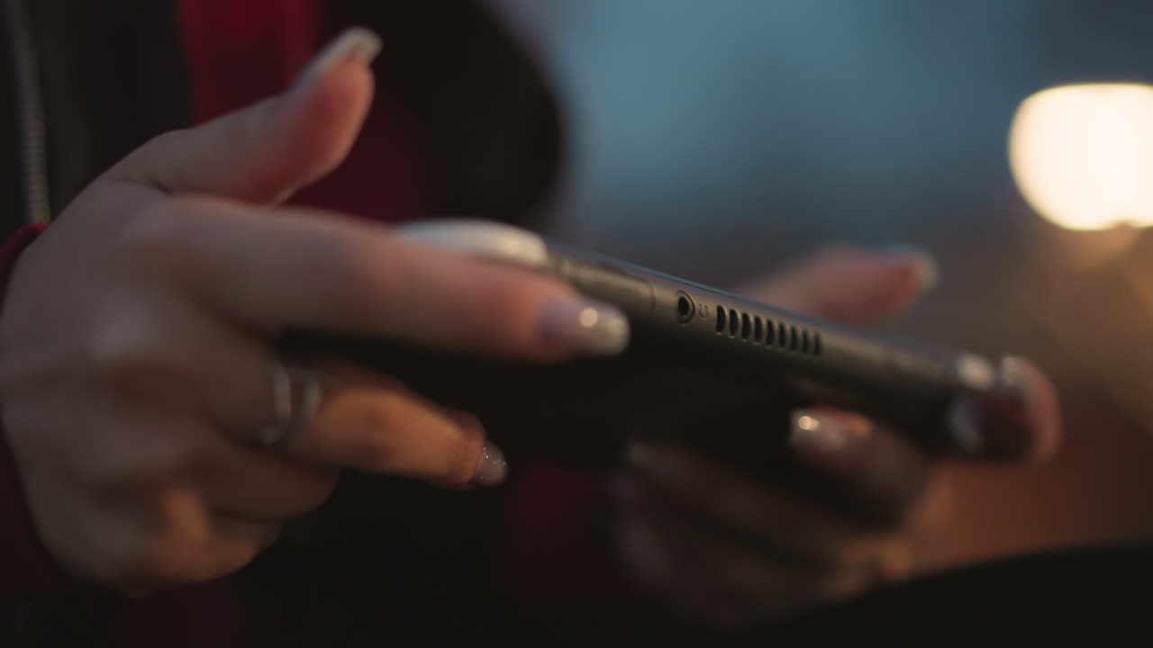 Closeup Of Textured Device Handling, Macro Image Showing Fingers Adjusting Ergonomic Device At Dusk, Closeup Of Manicured Fingers Exploring And Adjusting Handheld Device In Low Light Conditions