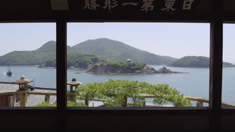 slow motion dolly in at fukuzenji temple in japan looking out on island scenery