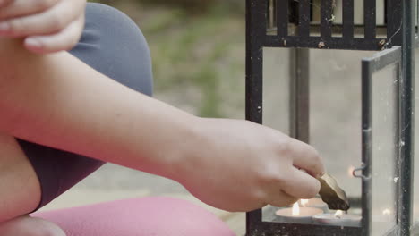 Close-up-shot-of-womans-hands-burning-wood-sticks-palo-santo