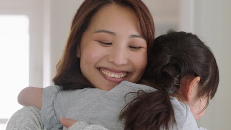 happy little asian girl hugging mother smiling embracing daughter enjoying motherly love cute child giving hug to mom showing affection at home family concept 4k footage